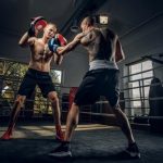 Boxer and coach working the pads