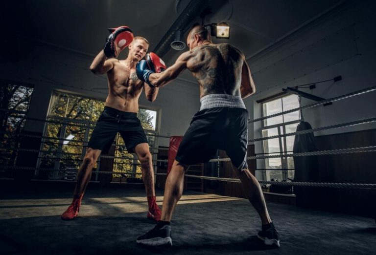 Boxer and coach working the pads